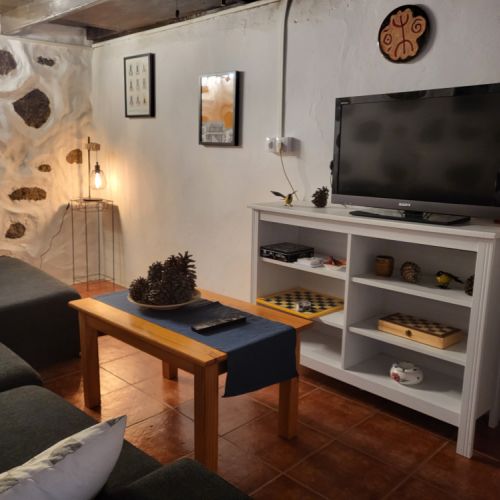 Coffee table, TV cabinet, and television with Google Chromecast.